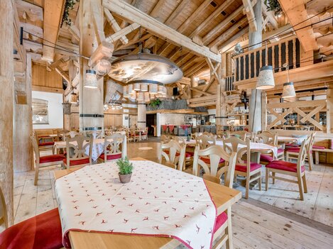 A rustic restaurant with wooden decor and cozy tables. The warm colors and inviting atmosphere create a pleasant place to eat.