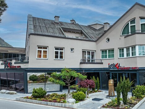 A modern building with a restaurant area and well-maintained garden facilities. The architecture is appealing and the surroundings invite you to linger.