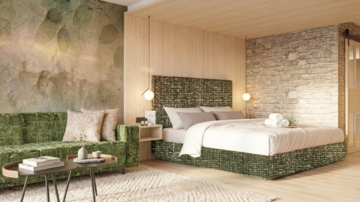 Ein modernes Zimmer mit einem gemütlichen Bett und einer eleganten Sitzecke. Die Wände sind mit Holz und Stein gestaltet, was eine warme Atmosphäre schafft.